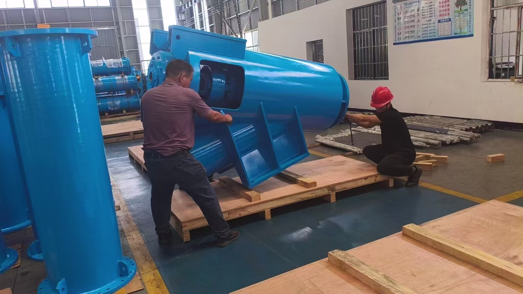 two men are packaging a vertical turbine pumps